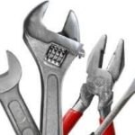 Various plumbing hand tools including adjustable wrenches and pliers from Marc Francis Plumbing for repiping services.