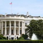 The White House with columns, American flag, and fountain in front, representing plumbing history in Johnson City, TN.