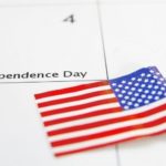 Calendar page with July 4 marked for Independence Day and American flag, related to plumbing tips for celebrations.