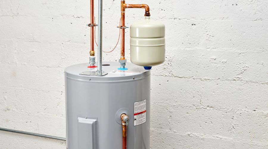 Water heater with copper pipes and an expansion tank, showing labeled connections and safety instructions.