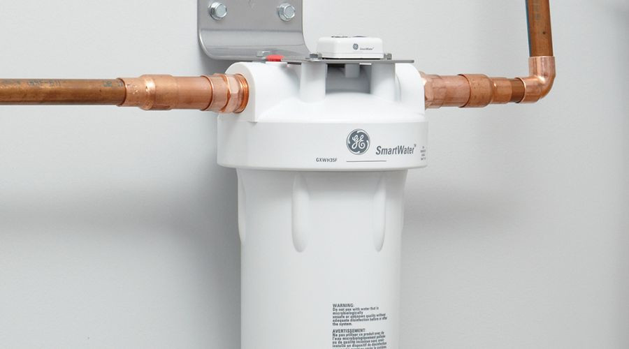 Whole-house water filter system with copper plumbing connections, showcasing eco-friendly plumbing solutions by Marc Francis Plumbing.