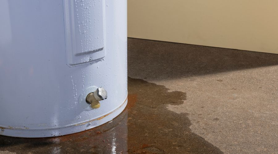 Water heater with visible water leakage on the floor, highlighting signs of potential water heater issues.