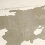 Water-stained concrete slab showing signs of potential slab leak damage, illustrating the importance of early detection and repair by plumbing professionals.